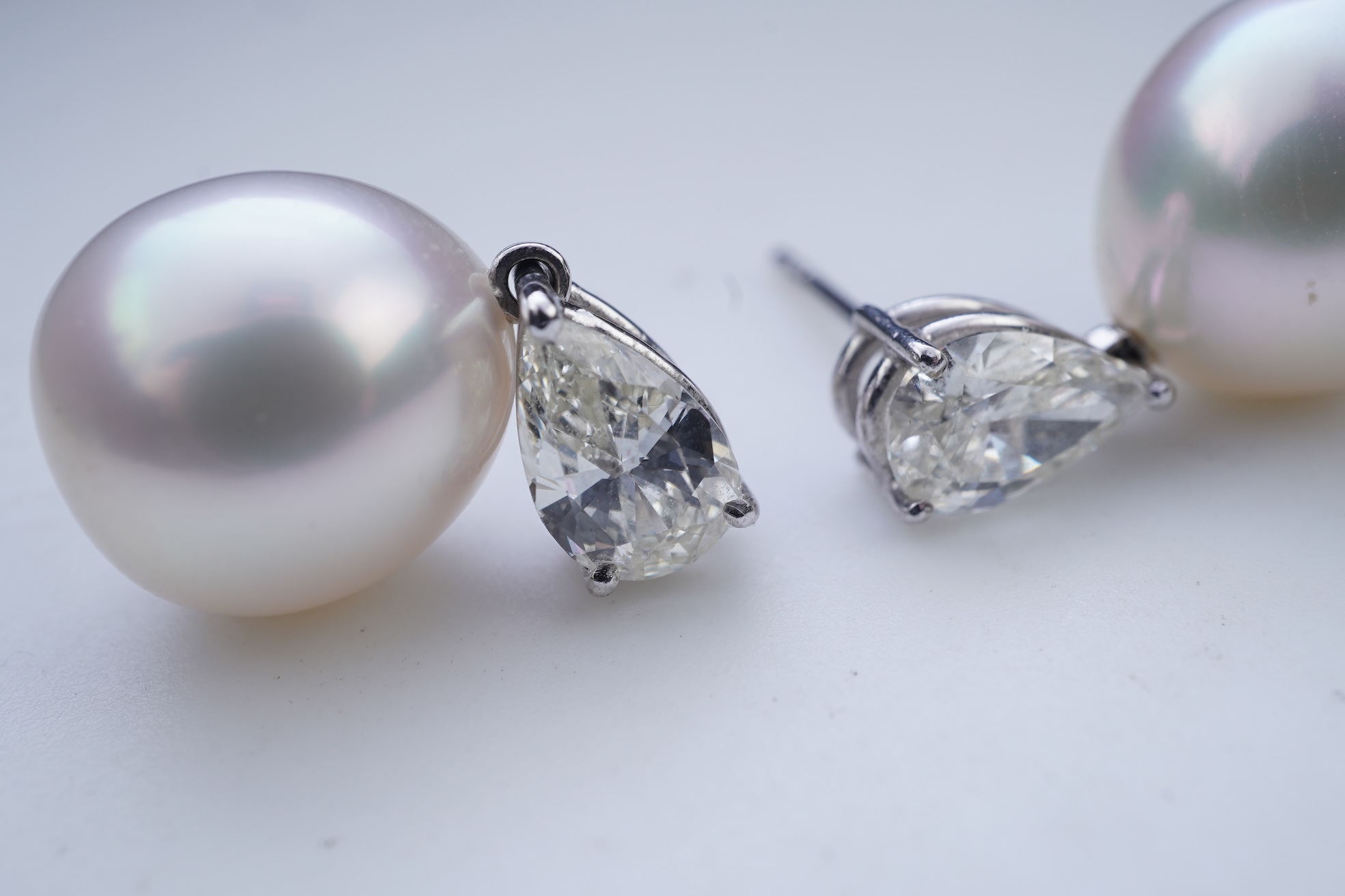 A pair of cultured pearl and diamond earrings